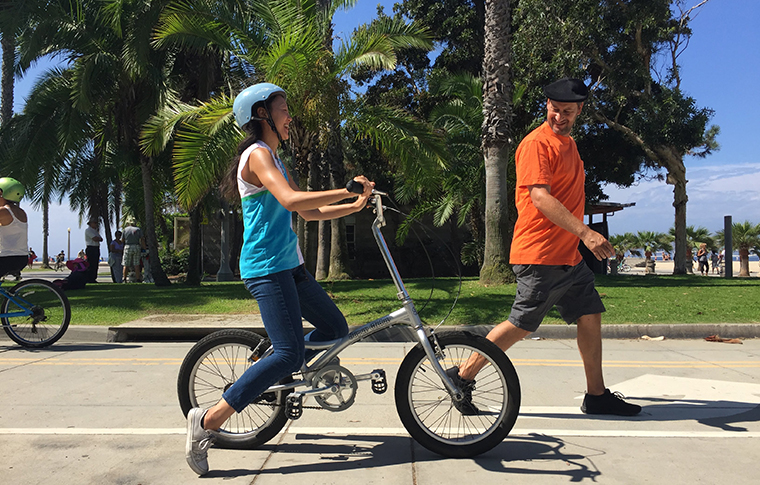 instructor teaching how to ride a bike